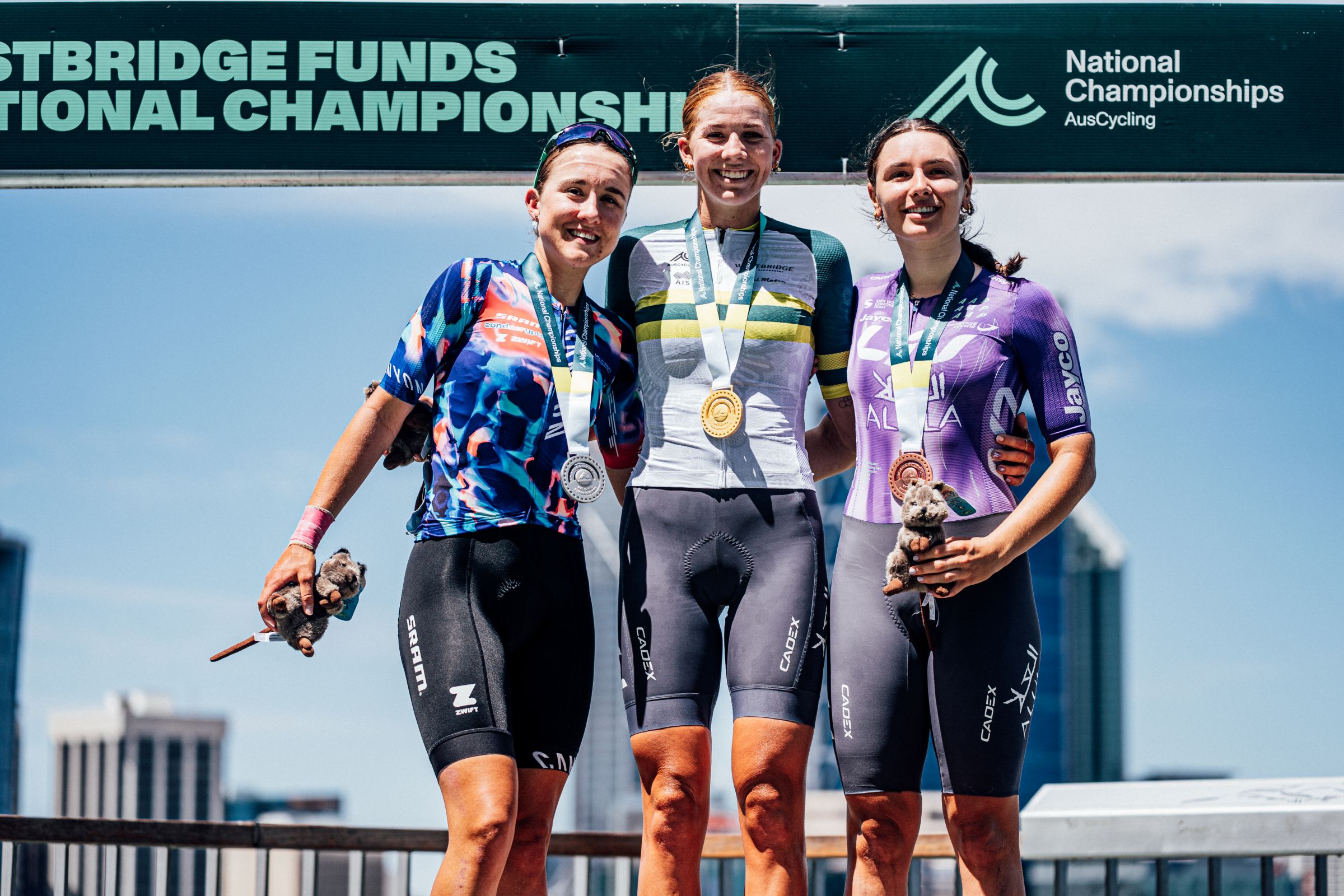 Mackenzie Coupland, Emily Dixon and Sophie Marr on the podium of the under-23 women road race at the 2026 Westbridge Funds Road National Championships in Kings Park, Perth, Western Australia